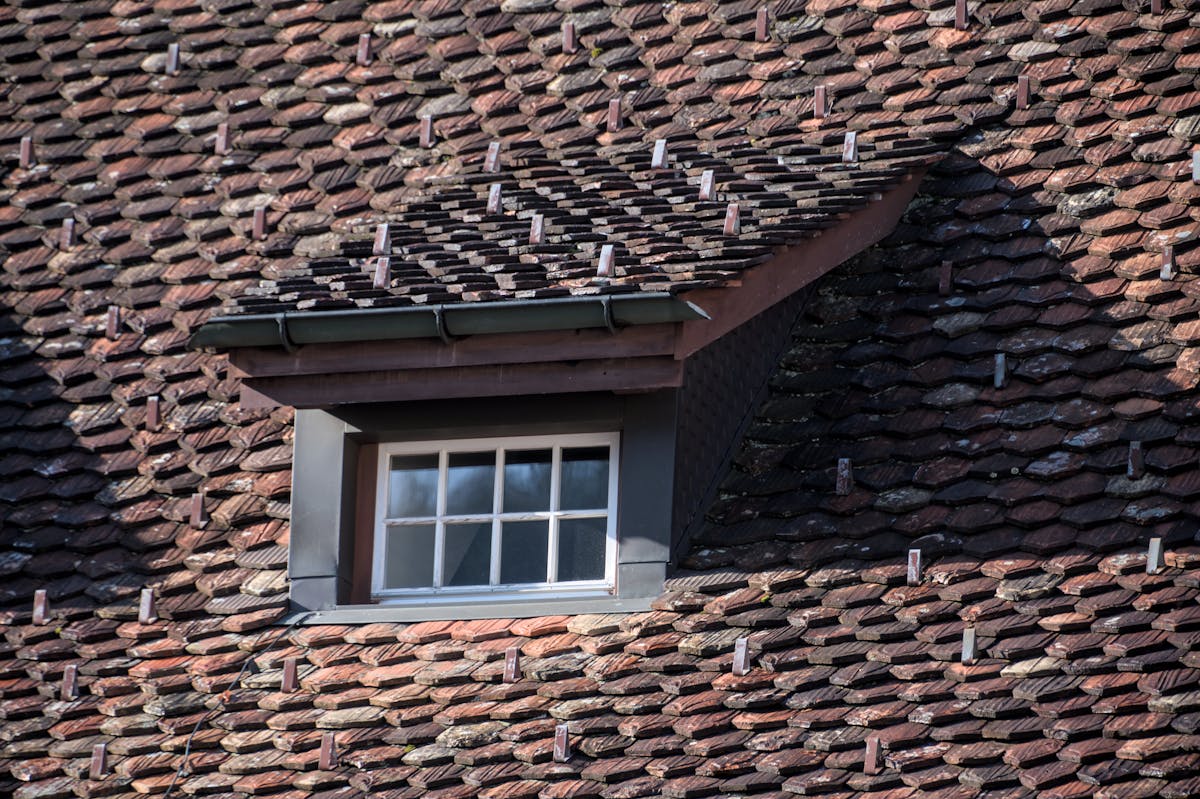 Licensed roofing contractor working on a residential roof installation