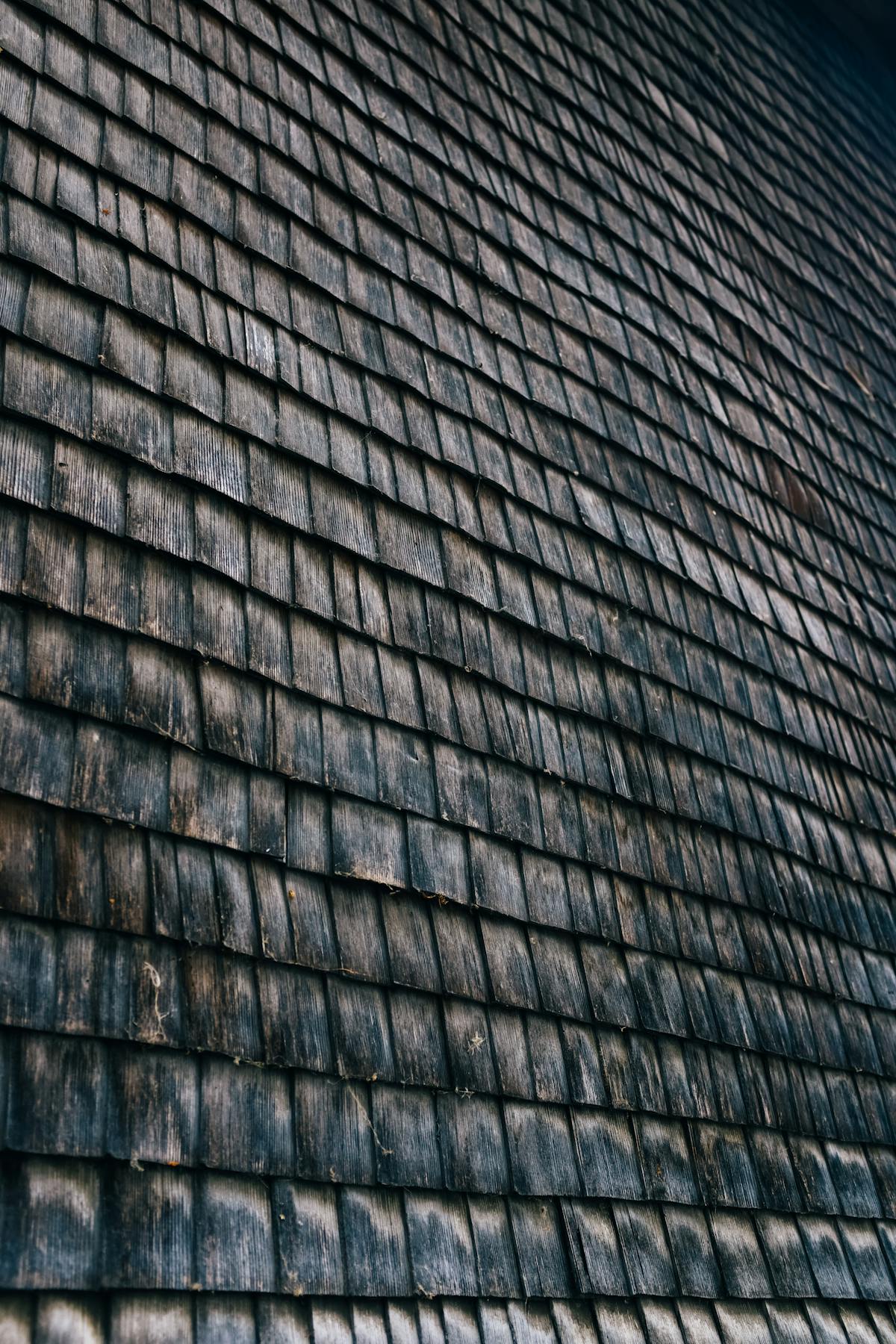 Asphalt shingle roof under installation showing layered material and underlayment