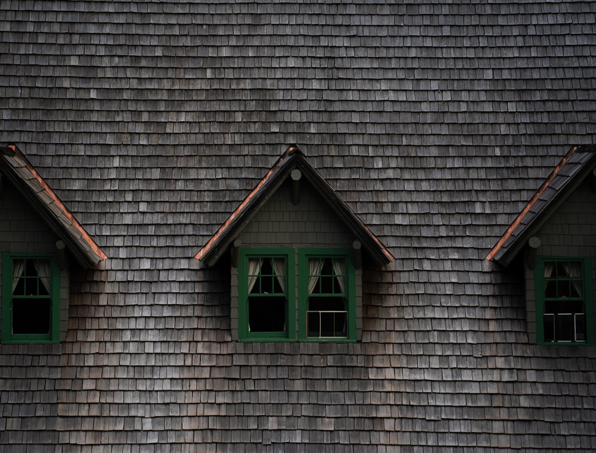 Storm damaged residential roof with debris and missing shingles after severe weather